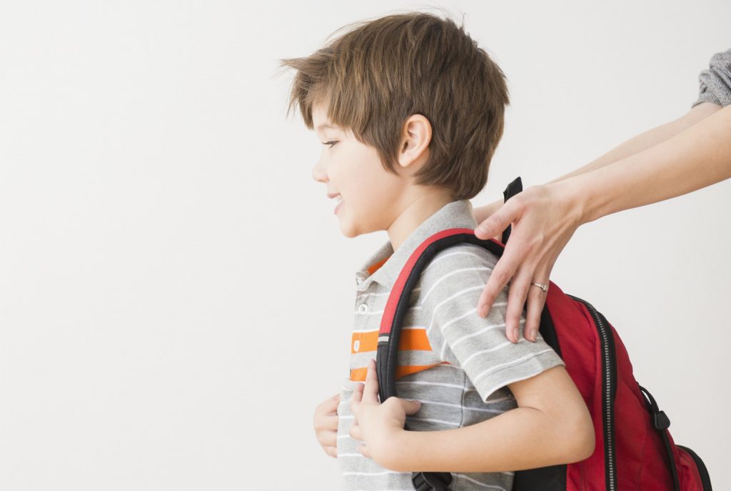 Hispanic mother rushing son to school